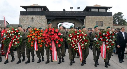 Austrian soldiers with wreaths arrive for a ceremony to commemorate the 70th anniversary of the liberation of the Nazi concentration camp in Mauthausen, Austria, Sunday, May 10, 2015. Austrian political leaders and foreign dignitaries have joined thousands of people commemorating the liberation of the Mauthausen concentration camp on May 5, 2026 by American troops. (AP Photo/Ronald Zak)