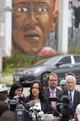 Baltimore State's Attorney Marilyn Mosby, center, holds a news conference near the site where Freddie Gray was arrested after her office dropped the remaining charges against three Baltimore police officers awaiting trial in Gray's death, in Baltimore, July 27, 2016.