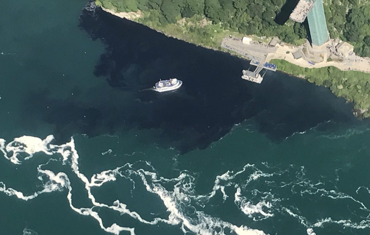 Black discharge from the Niagara Falls Waste Water Treatment Plant engulfs the Maid of the Mist docks. How the Niagara River looked at 4:18 p.m. Saturday. (Courtesy of Rainbow Air Inc.)
