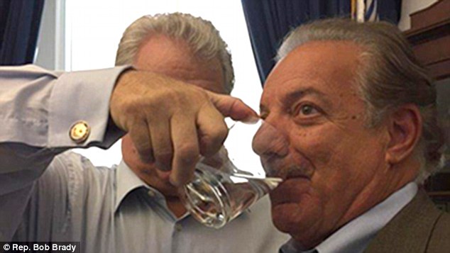 Messiah: Brady poured the liquid into the mouths of others rather than letting them hold the glass and had his staff send out the photos (above with constituent Ernie DeNofa)