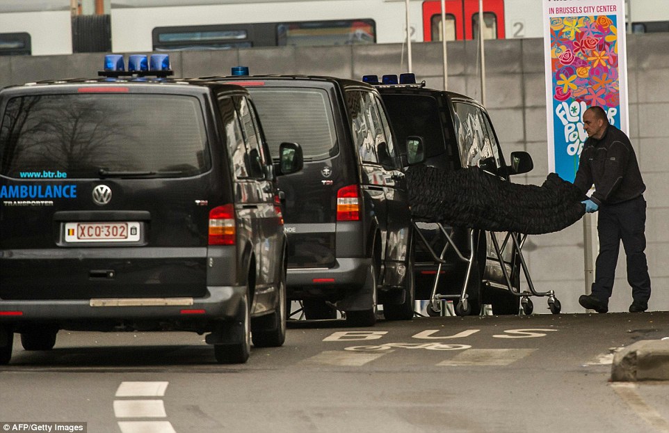 Tragic: One of the 20 people killed in the Maelbeek metro is taken from the station in a body bag this morning as Belgium starts three days of mourning after the worst terror attacks in its history