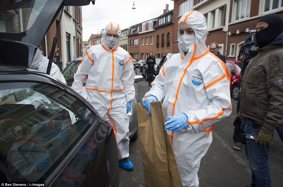 New raid: Special forces stormed a pizzeria in Anderlecht at just after dawn this morning - with some Belgian media wrongly claiming Najim Laachraoui was inside. Forensics officers took away evidence in brown bags after a man and two women were taken into custody 