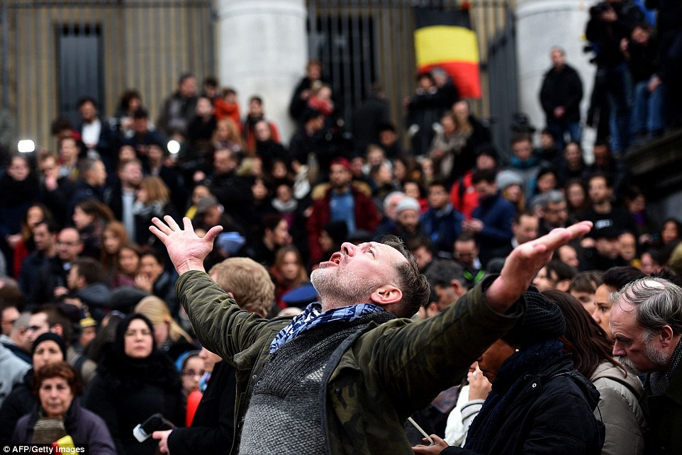 Anger: An overwhelmed mourner yells to the skies in Place De La Bourse as he and thousands of other met to show their defiance to the ISIS bombers who brought terror to their city yesterday