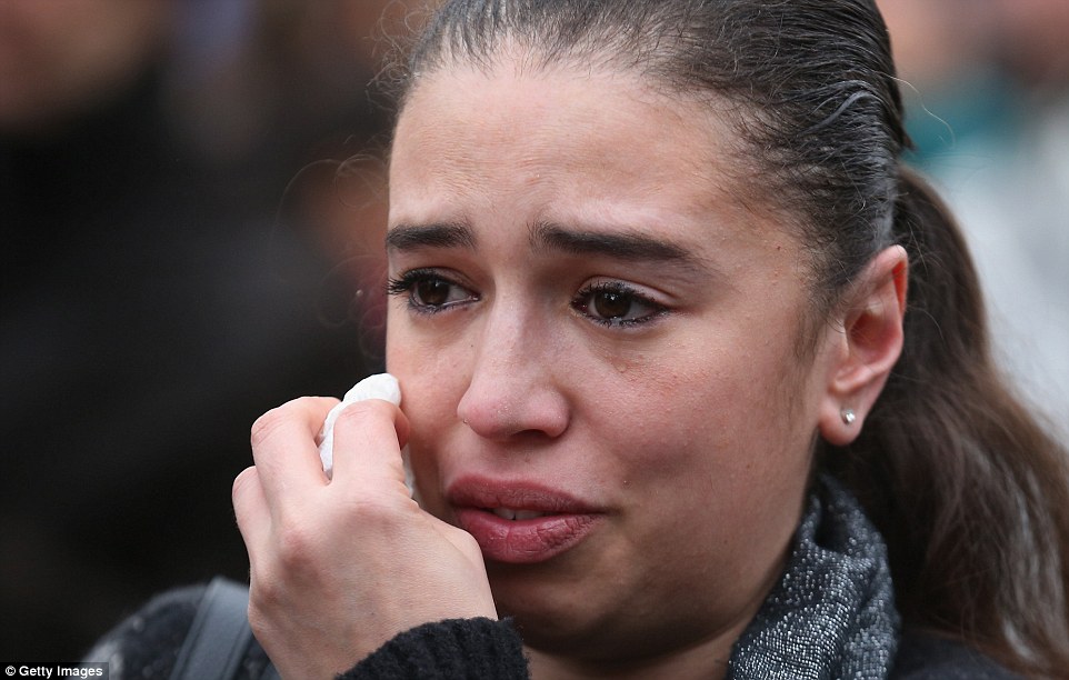 Sombre: A woman weeps after people observed a one minute silence at the Place De La Bourse in honour of the victims of yesterdays' terror attacks