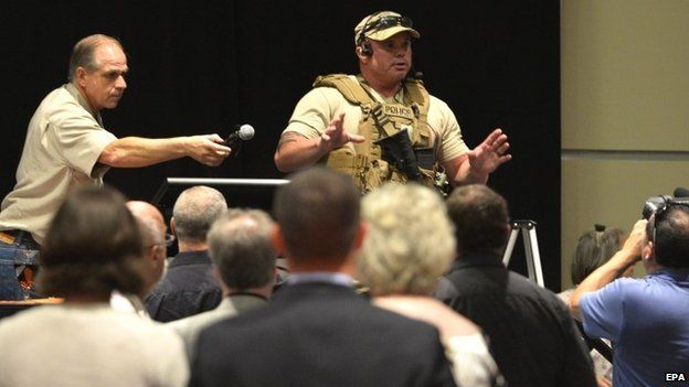 Police officer briefing conference attendees in Garland, Texas, 3 May 2026
