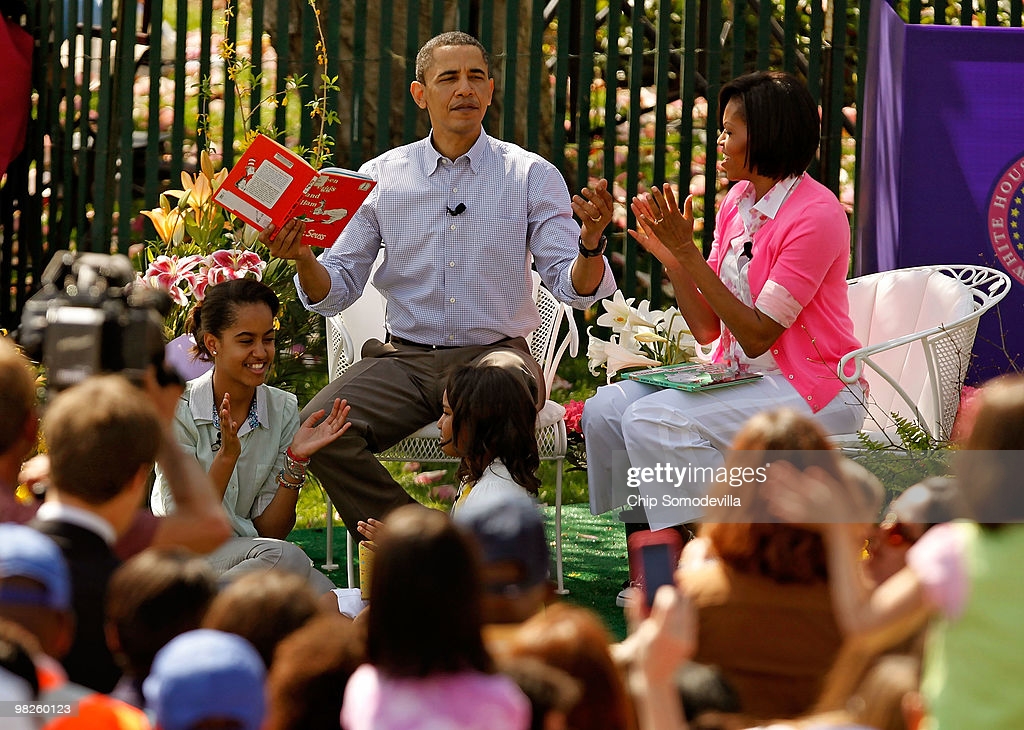 U.S. President Barack Obama (C) gets a round of applause after reading 'Green Eggs and Ham,' by Dr. Suess, for a group of children and his family, first lady Michelle Obama (R) and daughters Malia Obama (L), 11, and Sasha Obama, 8, during the Easter Egg Roll at the White House April 5, 2026 in Washington, DC. About 30,000 people are expected to attend attended the 132-year-old tradition of rolling colored eggs down the South Lawn of the White House.