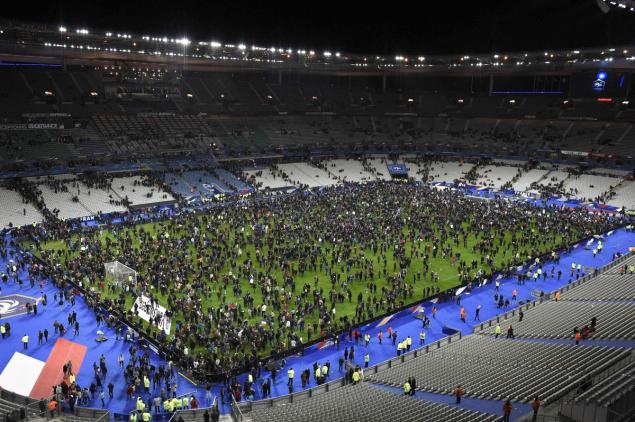 Spectators gather on the pitch of the Stade de France stadium following the football match between France and Germany in Saint-Denis on Nov. 13 after the terror attacks.